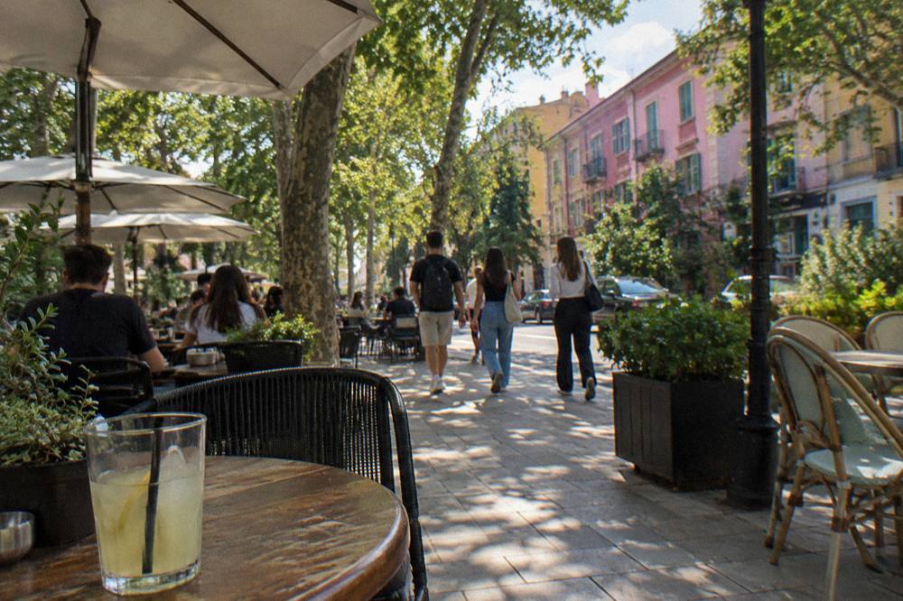 Cafe tables on a leafy street in the Blloku quarter of Tirana in the evening