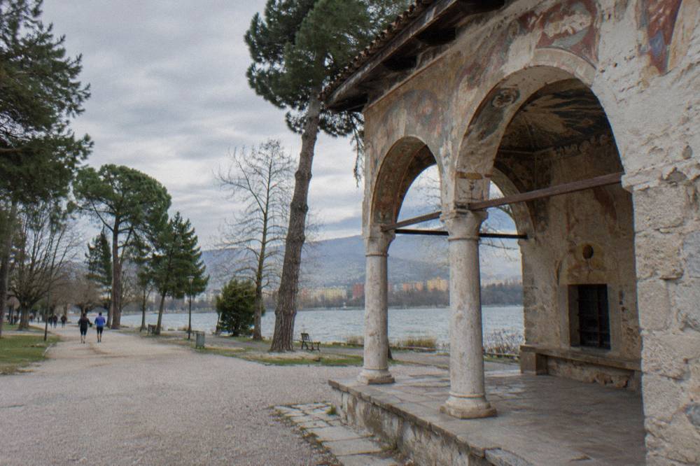 The frescoed porch of a small Ottoman mosque with frescoes above its arches