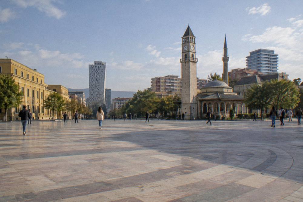 Open pedestrian expanse of Skanderbeg Square in Tirana on a clear day