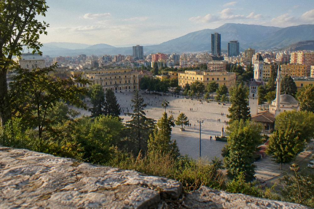 Panorama of Tirana seen from a green ridge on Mount Dajti under a clear sky