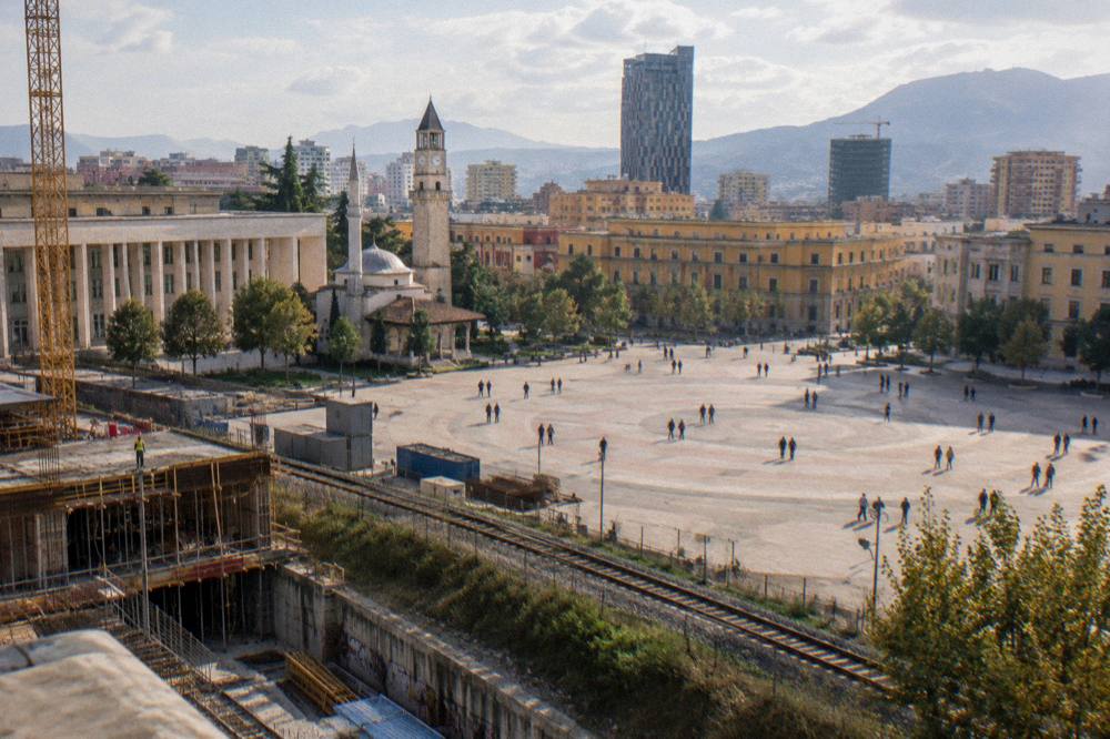A construction site beside a railway embankment on the edge of Tirana