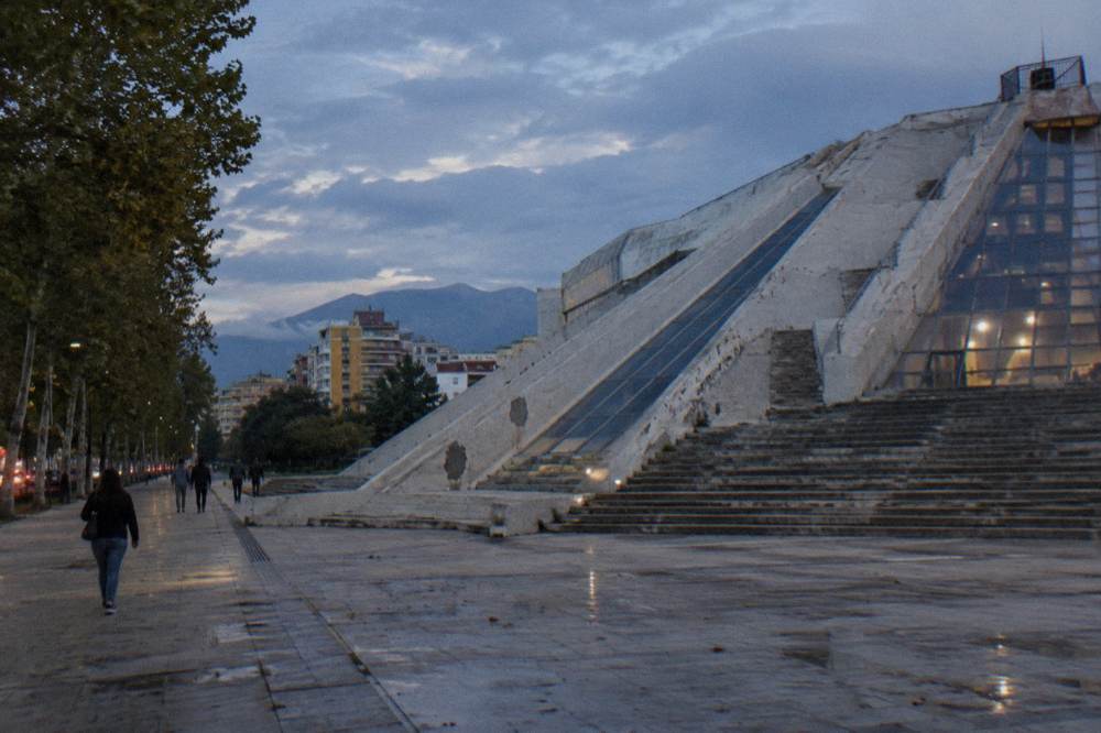The concrete facade and outdoor steps of the renovated Pyramid of Tirana at dusk