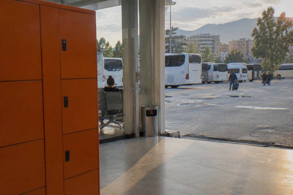 A row of orange automated lockers of different sizes in a bright entrance hall