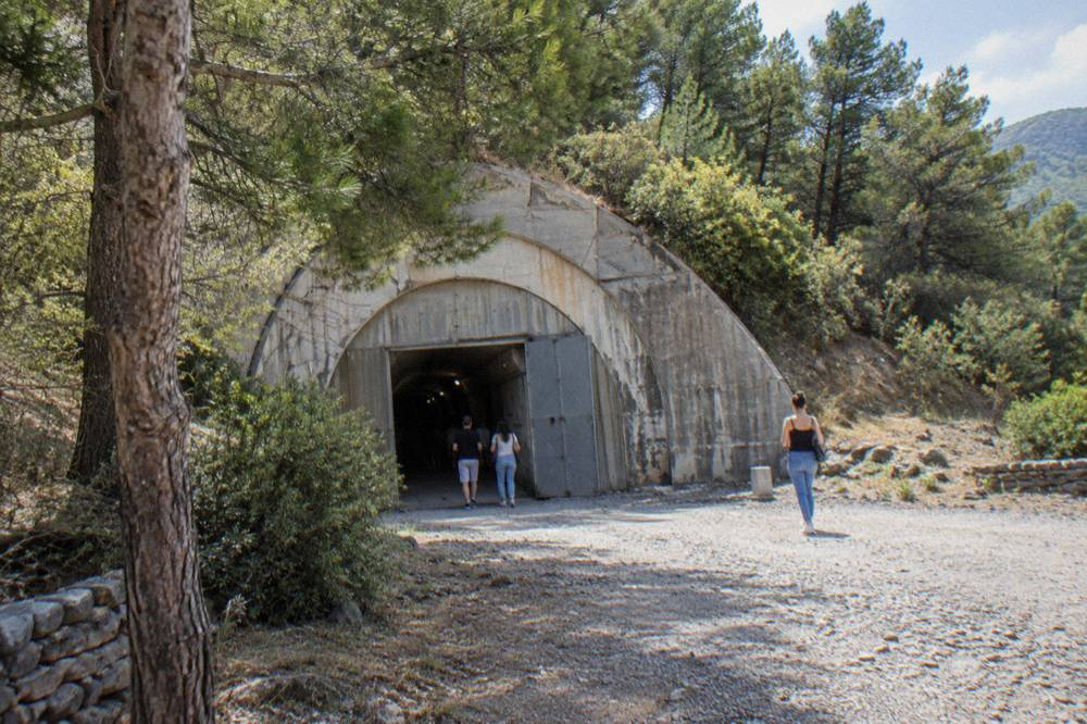 A long underground tunnel with exhibition panels inside a former bunker in Tirana