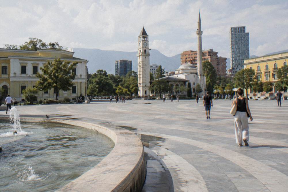 A small historic villa facade with museum signage on a quiet street in central Tirana