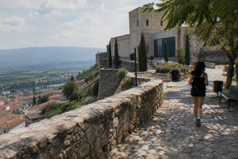 A hilltop museum inside an old stone castle above a historic town in Albania