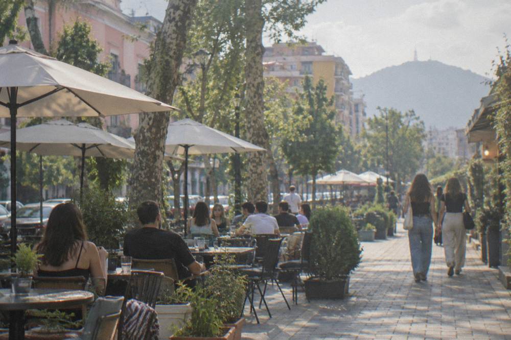 Outdoor cafe tables on a city street in the evening