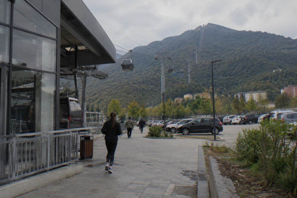 The Dajti Ekspres cable car cabins rising over green slopes toward Mount Dajti