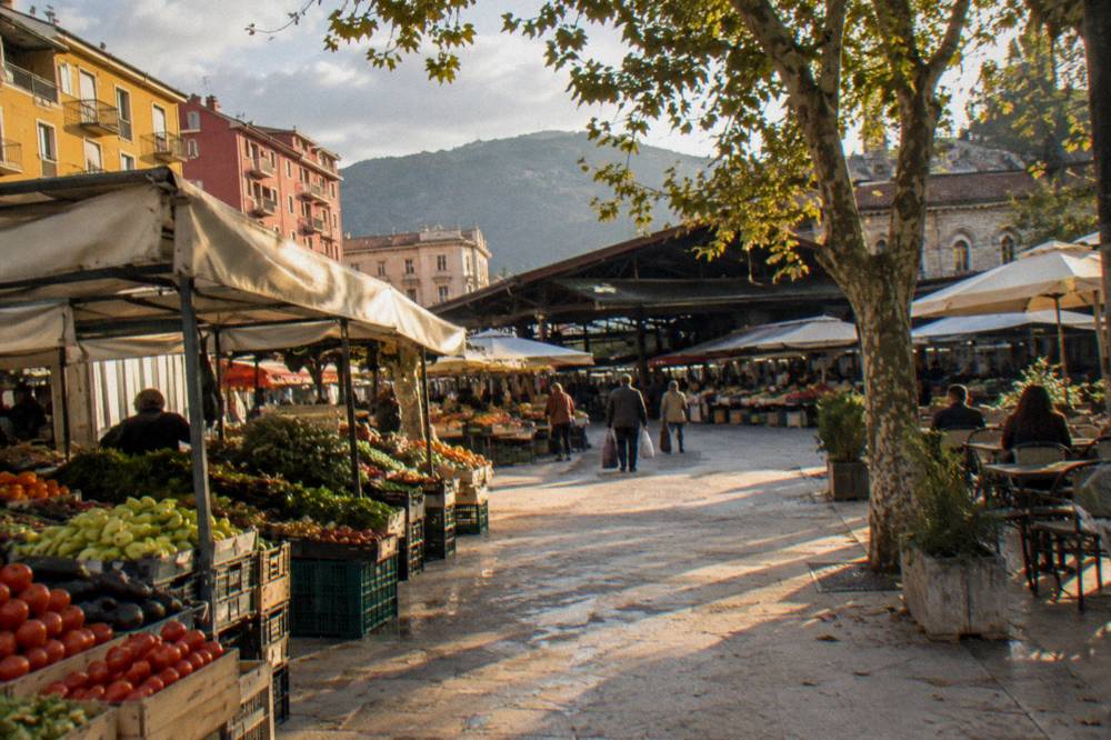 Produce stalls and painted shopfronts at the New Bazaar in Tirana