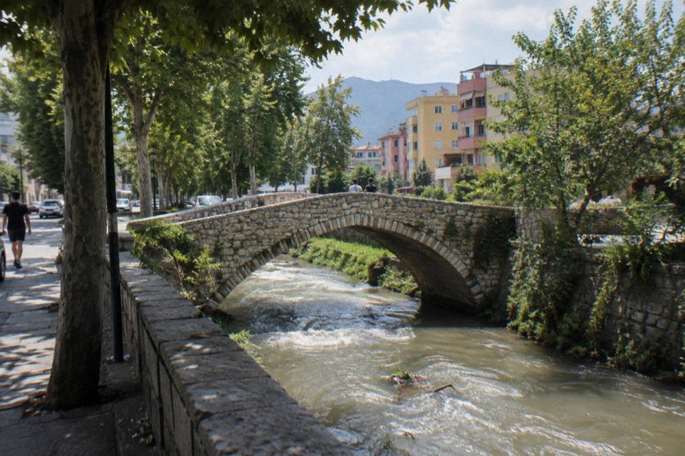 The stone Tanners' Bridge on a quiet Tirana street