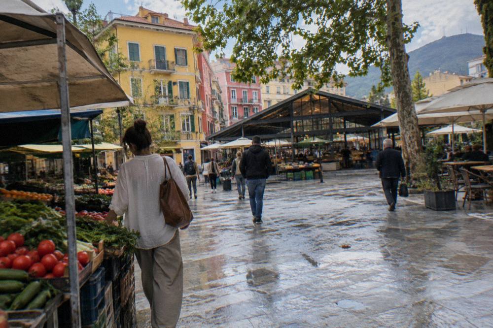 Shoppers walking past colourful facades near the New Bazaar in Tirana