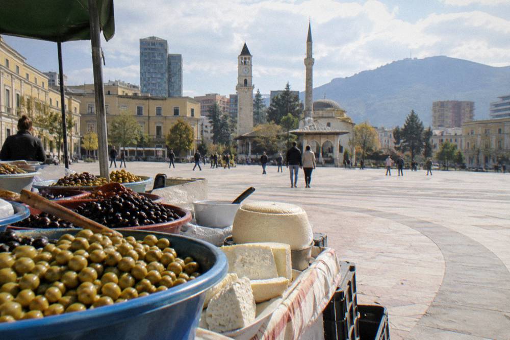 A market stall displaying olives and local cheese in bowls in Tirana