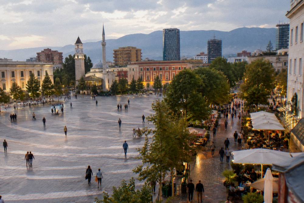 Evening lights over a busy pedestrian street with cafes in Tirana