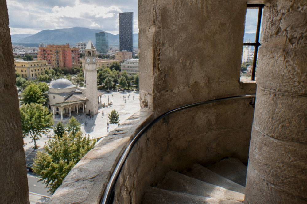 A narrow stone spiral staircase inside an old clock tower