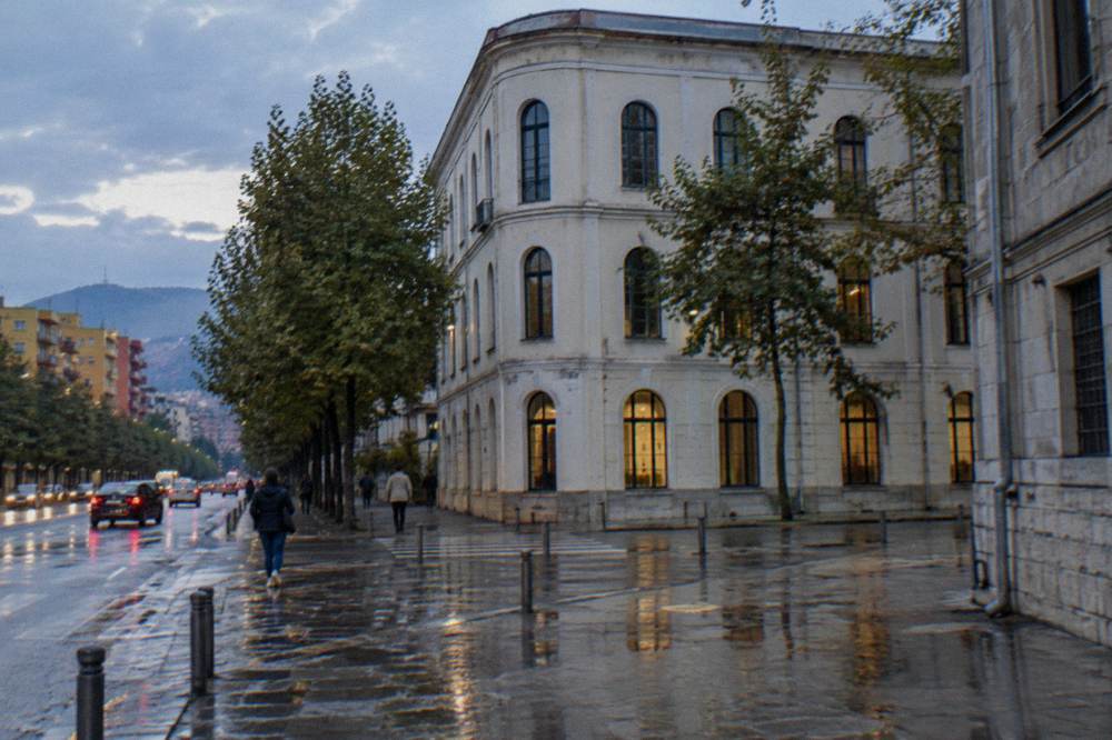 Wet pavement outside the House of Leaves museum in Tirana after rain