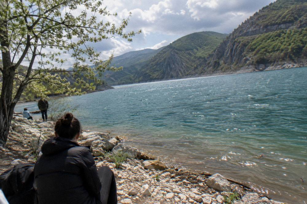 Lake Bovilla near Tirana surrounded by green hills under a spring sky