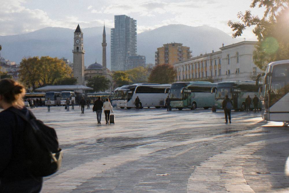 Intercity buses parked in rows at a bus terminal in Tirana
