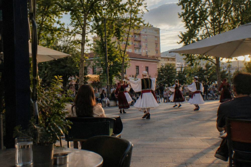 Folk dancers in traditional Albanian costume performing at an evening show