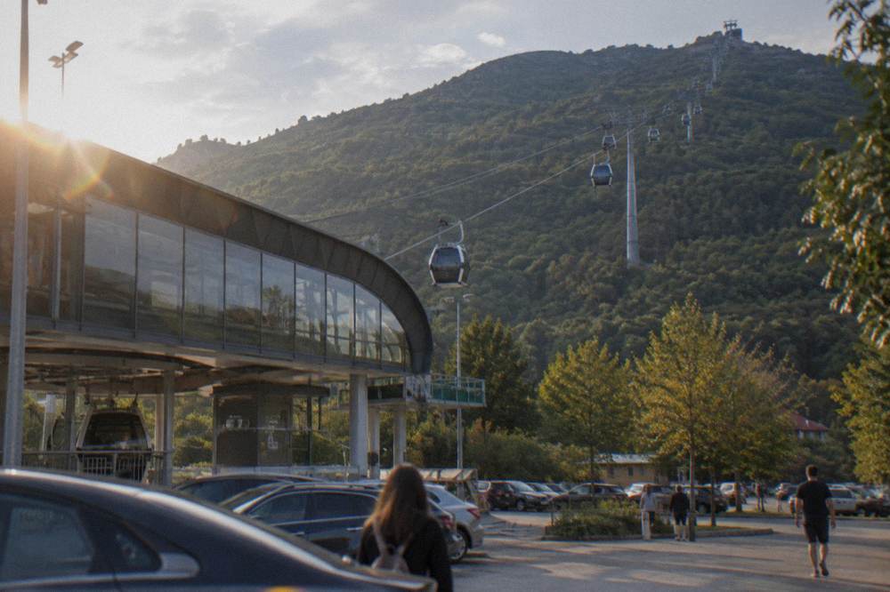 The Dajti Ekspres cable car cabins travelling on their line up the forested mountain slope