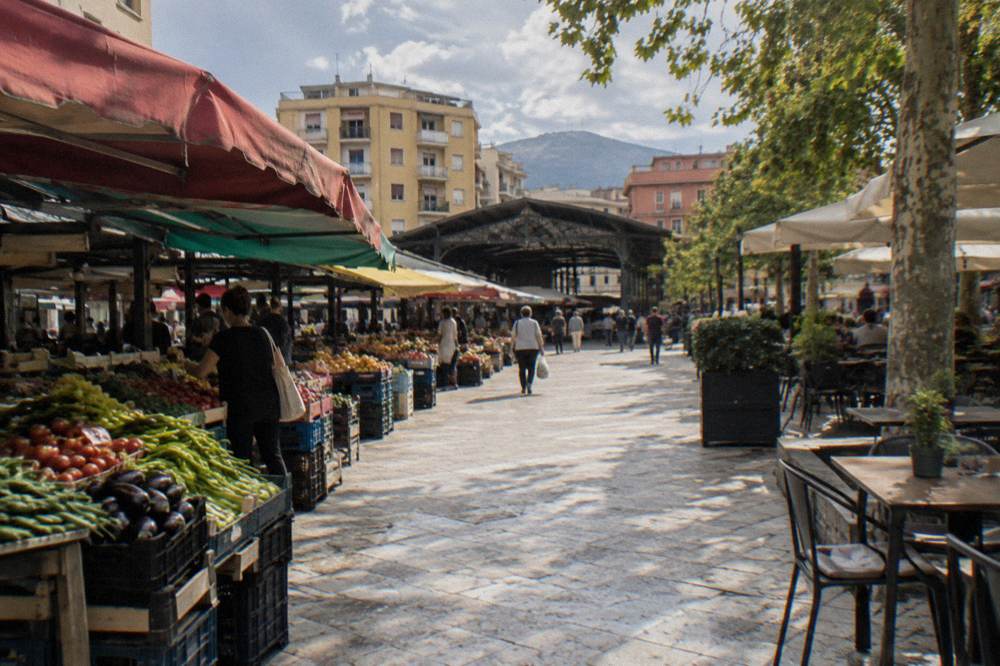 Produce stalls under colourful awnings at the New Bazaar in Tirana