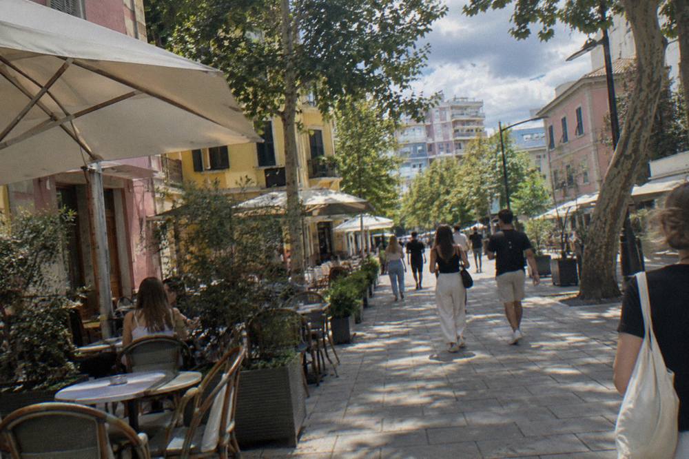 Colourful facades and cafe tables on a pedestrian street in the Blloku quarter of Tirana