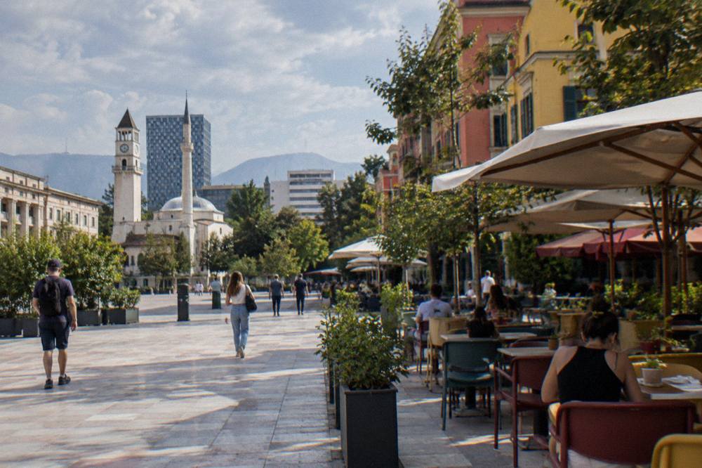 Colourful buildings and cafe tables on a pedestrian street in central Tirana