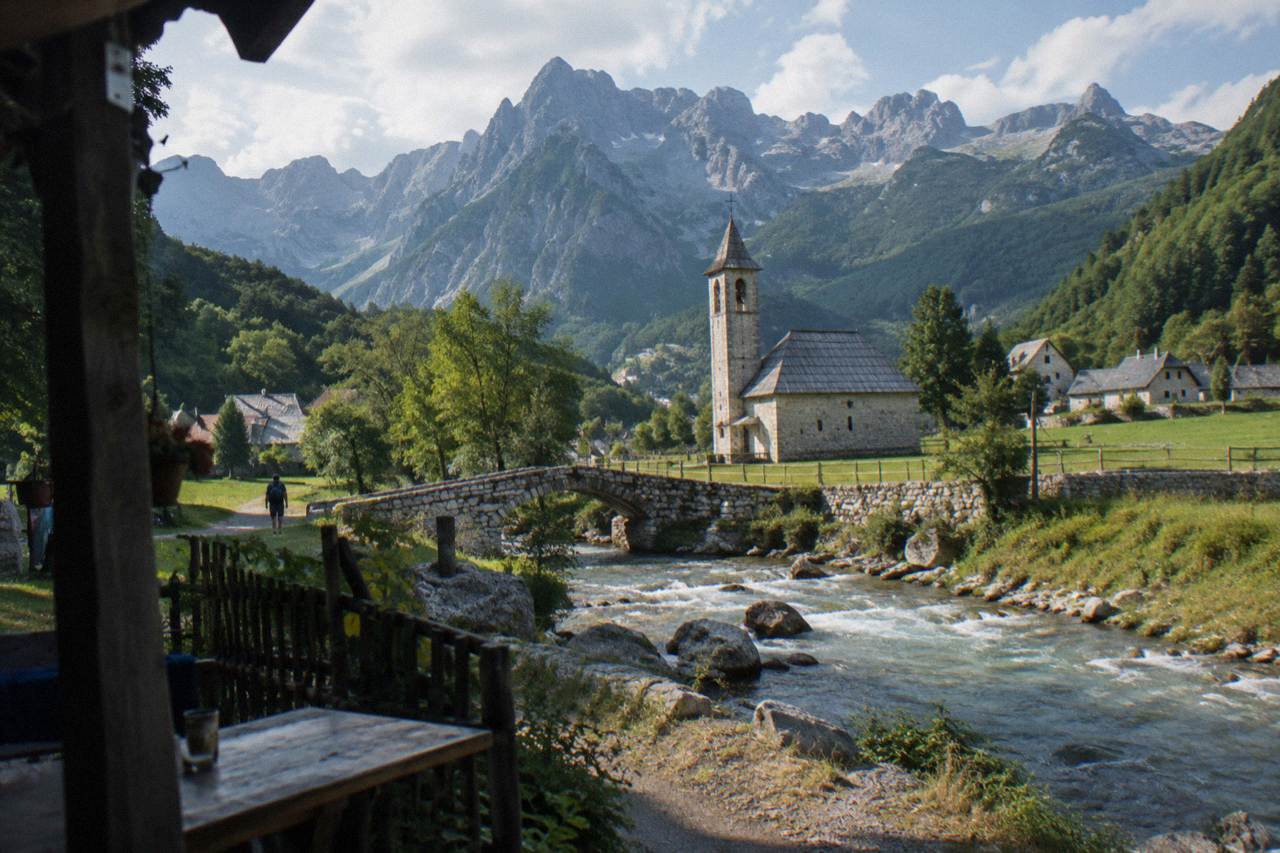 Mountain peaks of the Albanian Alps rising above a green valley near Theth