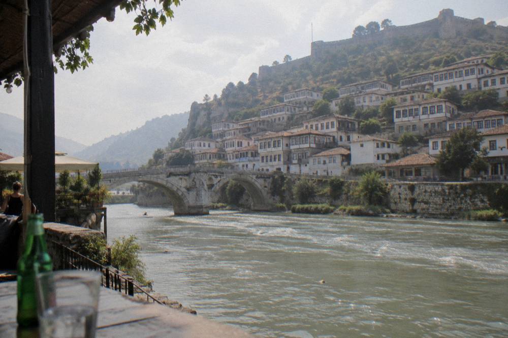 White Ottoman houses on the hillside of Berat old town under a castle wall