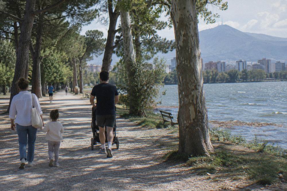 Family walking in a sunny city park